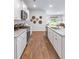 Modern kitchen with white cabinets, granite countertops, and stainless steel appliances at 630 Sweet Ramble Way, Summerville, SC 29486