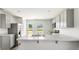 Modern kitchen with gray cabinets and breakfast bar at 168 River Hill Rd, Goose Creek, SC 29445