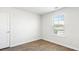 Bright bedroom with wood-look flooring and large window at 168 River Hill Rd, Goose Creek, SC 29445