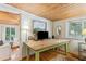 Bright home office features a large rustic desk, hardwood floors, and natural light at 412 E Hudson Ave, Folly Beach, SC 29439