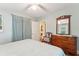 Bedroom with queen bed, dresser, and access to another room at 412 E Hudson Ave, Folly Beach, SC 29439
