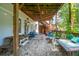 Spacious basement patio with gravel flooring, wooden furniture and multiple seating areas at 412 E Hudson Ave, Folly Beach, SC 29439