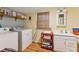 Laundry room with washer, dryer, and storage shelves at 412 E Hudson Ave, Folly Beach, SC 29439