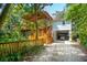 Two-story home with wrap-around porch and golf cart garage at 412 E Hudson Ave, Folly Beach, SC 29439