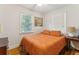 Bedroom with queen bed, hardwood floors, and ceiling fan at 412 E Hudson Ave, Folly Beach, SC 29439