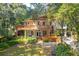 Two-story home with large deck, lush landscaping, and spacious backyard at 412 E Hudson Ave, Folly Beach, SC 29439