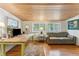 Home office with wood desk, hardwood floors, and a cozy leather sofa at 412 E Hudson Ave, Folly Beach, SC 29439