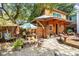 Landscaped backyard with whimsical art installations and a wooden building at 412 E Hudson Ave, Folly Beach, SC 29439