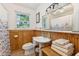 Clean bathroom with wood-paneled walls and a pedestal sink at 412 E Hudson Ave, Folly Beach, SC 29439