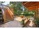 Spacious wooden deck with stairs, seating area, and lush landscaping at 412 E Hudson Ave, Folly Beach, SC 29439