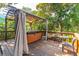 Deck with a hot tub, covered pergola, and outdoor seating area at 412 E Hudson Ave, Folly Beach, SC 29439
