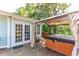 Deck with hot tub, pergola, and French doors leading inside at 412 E Hudson Ave, Folly Beach, SC 29439