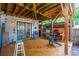 Covered deck with wooden ceiling, and access to interior at 412 E Hudson Ave, Folly Beach, SC 29439