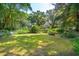 Spacious backyard with lush greenery and a large lawn area at 412 E Hudson Ave, Folly Beach, SC 29439