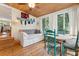 Relaxing sunroom with built-in daybed, dining area, and access to a deck at 412 E Hudson Ave, Folly Beach, SC 29439