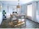 Bright dining room with hardwood floors, wooden table, and six chairs at 1687 Cultivation Ln # 461, Mount Pleasant, SC 29466