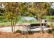 Brick fire pit with seating area in a tranquil park setting at 1687 Cultivation Ln # 461, Mount Pleasant, SC 29466