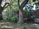 Screened porch and brick home nestled amongst mature oak trees at 2320 S Lander Ln, Charleston, SC 29414