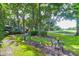 Landscaped backyard oasis with bird bath, small table, and lush greenery at 10 Trail Hollow Dr, Charleston, SC 29414