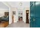 Bright entryway with tile floors, a view into the living room, and a dark teal door at 10 Trail Hollow Dr, Charleston, SC 29414