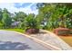 Circular driveway with lush landscaping leading to a charming house at 10 Trail Hollow Dr, Charleston, SC 29414