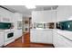 Bright eat-in kitchen, white cabinets, and hardwood floors at 10 Trail Hollow Dr, Charleston, SC 29414