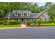 Brick house with a gray roof, green shutters, and a landscaped yard at 10 Trail Hollow Dr, Charleston, SC 29414