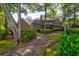 Brick house exterior with screened porch and lush landscaping at 10 Trail Hollow Dr, Charleston, SC 29414