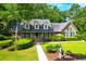 Brick home with green shutters and landscaped yard at 10 Trail Hollow Dr, Charleston, SC 29414