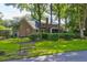 Brick house exterior with screened porch and lush landscaping at 10 Trail Hollow Dr, Charleston, SC 29414