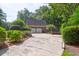 Two-car brick garage with lush landscaping and a spacious driveway at 10 Trail Hollow Dr, Charleston, SC 29414
