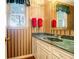 Charming bathroom with green marble vanity and striped wallpaper at 10 Trail Hollow Dr, Charleston, SC 29414