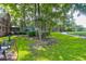 Spacious backyard with lush lawn, mature trees, and landscaping at 10 Trail Hollow Dr, Charleston, SC 29414
