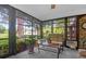 Bright sunroom with view of trees and comfortable seating at 10 Trail Hollow Dr, Charleston, SC 29414