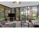 Sunroom with golf course view and comfortable seating at 10 Trail Hollow Dr, Charleston, SC 29414