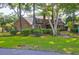 Brick house exterior with screened porch and lush landscaping at 10 Trail Hollow Dr, Charleston, SC 29414