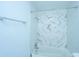 Bathroom with a bathtub, shower, and marble-style tile at 133 Marion Rd, Summerville, SC 29486