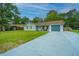 Newly renovated light gray house with a gray driveway and well-maintained lawn at 133 Marion Rd, Summerville, SC 29486