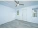 Bright bedroom with grey flooring, ceiling fan, and access to a full bathroom at 133 Marion Rd, Summerville, SC 29486