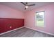 Bedroom with pink walls, wood-like flooring, and a ceiling fan at 133 Marion Rd, Summerville, SC 29486