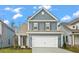 Two-story gray house with white garage door at 423 Grove End Rd, Moncks Corner, SC 29461