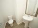 Simple powder room with pedestal sink and elegant mirror at 423 Grove End Rd, Moncks Corner, SC 29461