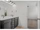 Bathroom with double vanity, dark cabinets, and a large mirror at 423 Grove End Rd, Moncks Corner, SC 29461