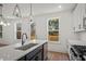 Bright kitchen island with sink, modern faucet, and stainless steel appliances at 423 Grove End Rd, Moncks Corner, SC 29461