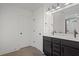 Modern bathroom with double vanity, quartz countertop, and dark cabinets at 423 Grove End Rd, Moncks Corner, SC 29461