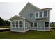 Two-story house with gray siding, a sunroom, and a nicely landscaped yard at 423 Grove End Rd, Moncks Corner, SC 29461