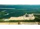 Aerial view of a new home community under construction, surrounded by trees and farmland at 5536 Bowmore Blvd, Ravenel, SC 29470