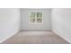 Spacious bedroom with neutral carpeting and large window at 5536 Bowmore Blvd, Ravenel, SC 29470