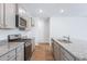 Modern kitchen with gray cabinets and granite countertops at 5536 Bowmore Blvd, Ravenel, SC 29470