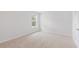 Bright bedroom with window, neutral carpet, and door at 5536 Bowmore Blvd, Ravenel, SC 29470